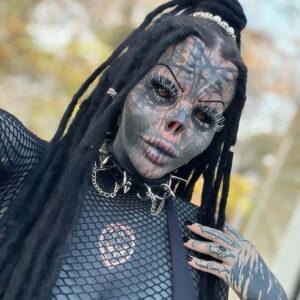 Toxii Daniëlle showcasing her heavily tattooed and modified look, with intricate designs covering her face and neck.