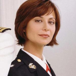 Catherine Bell appears in her Marine Corps uniform as Lt. Col. Sarah “Mac” MacKenzie, capturing the strength and authority that made her character unforgettable in JAG.